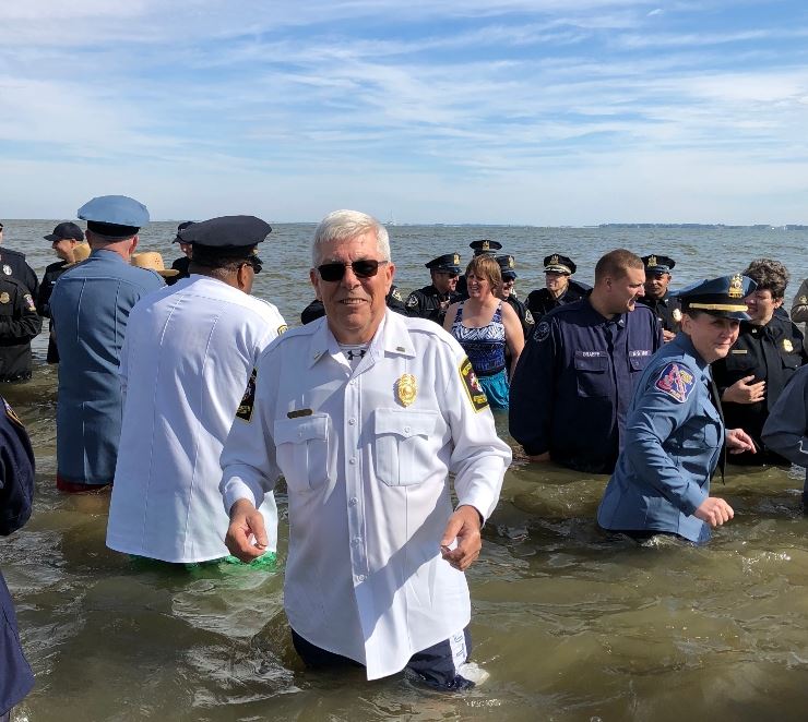 Lt. Enig standing in the bay for the promo of the Torch Run