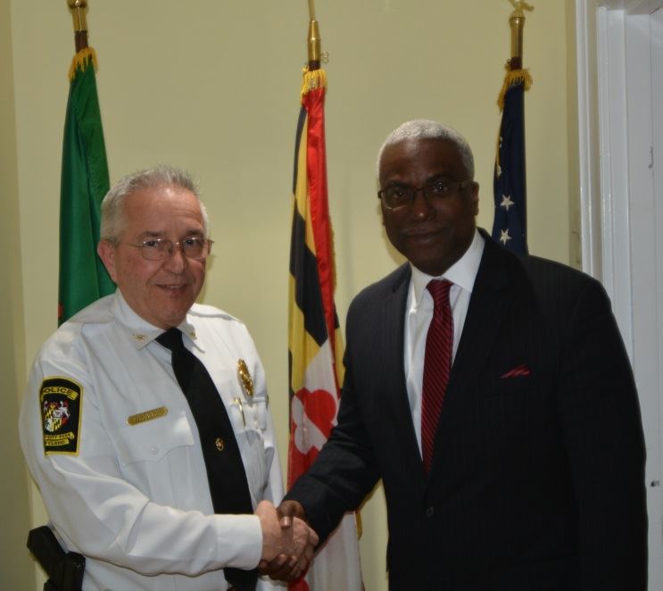 Chief Wynnyk and new Chief Baker shake hands