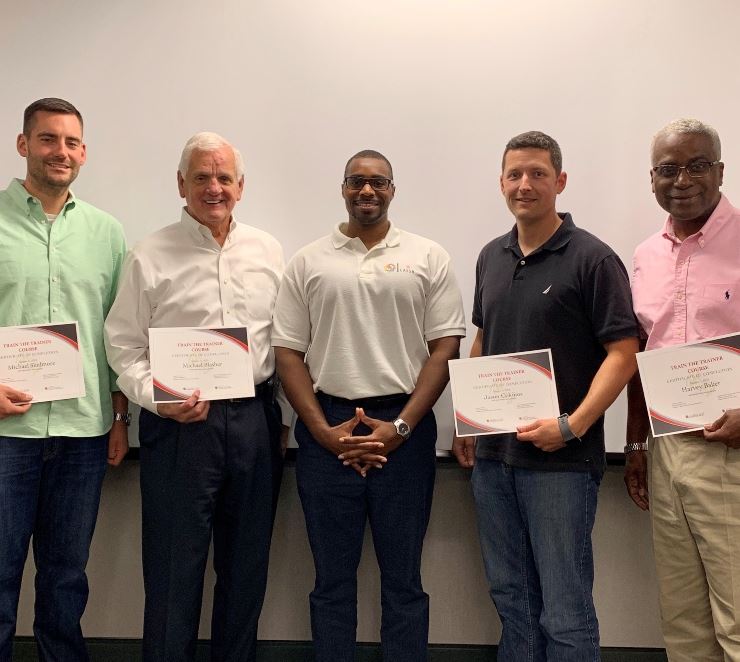 Chief standing with others who completed implicit bias training