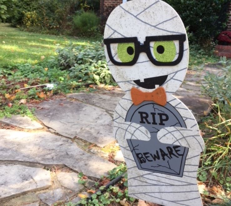 A Mummy Ghost holding a sign that says RIP Beware