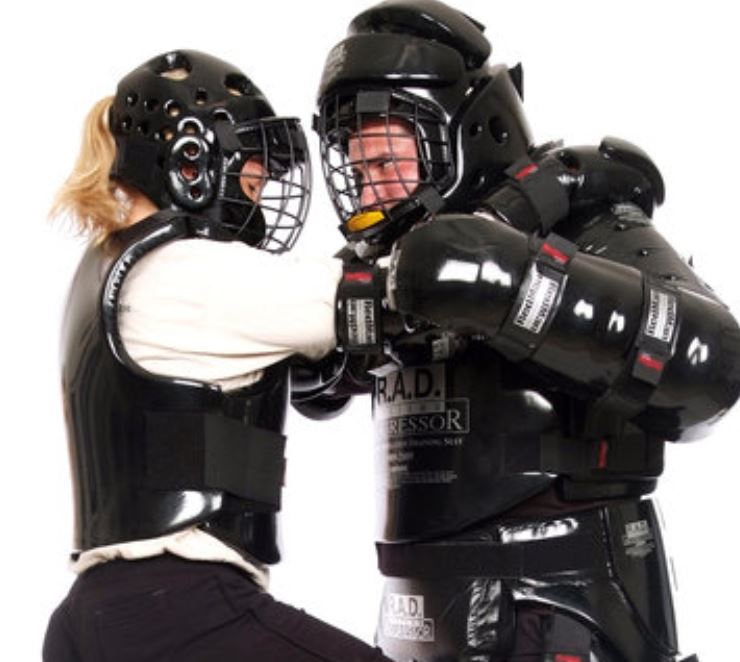 A man and women in self defense gear