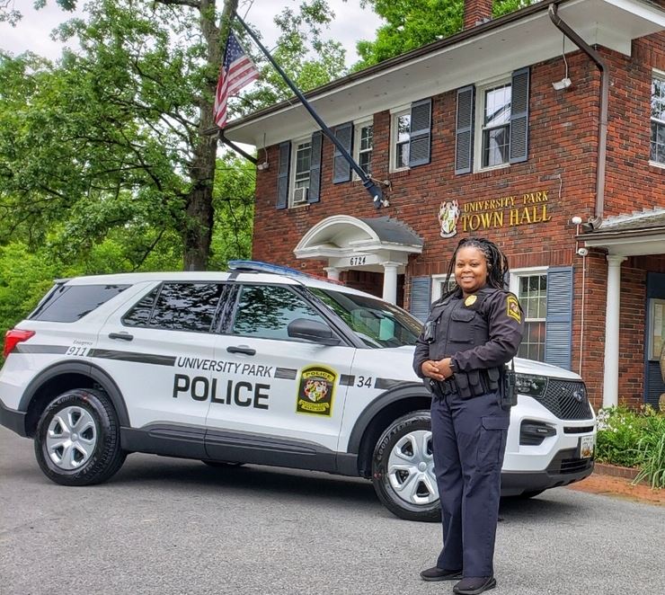 Officer Graddy stands with new 2020 Ford Hybrid SUV