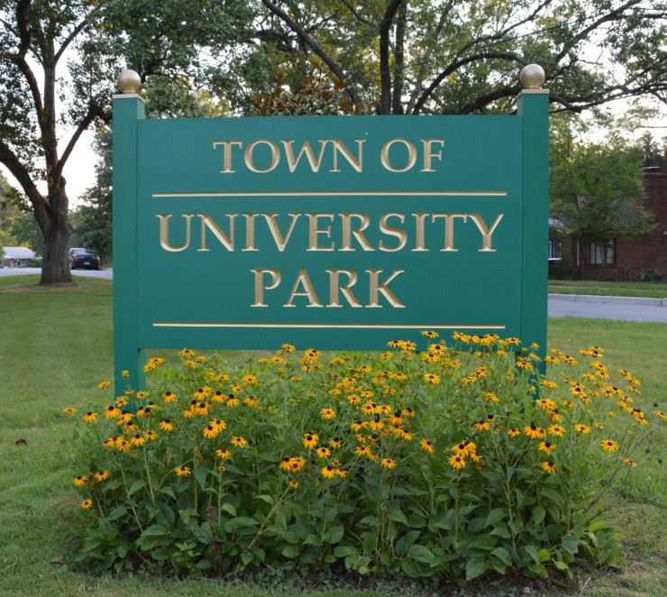 Town sign with black eyed susan flowers