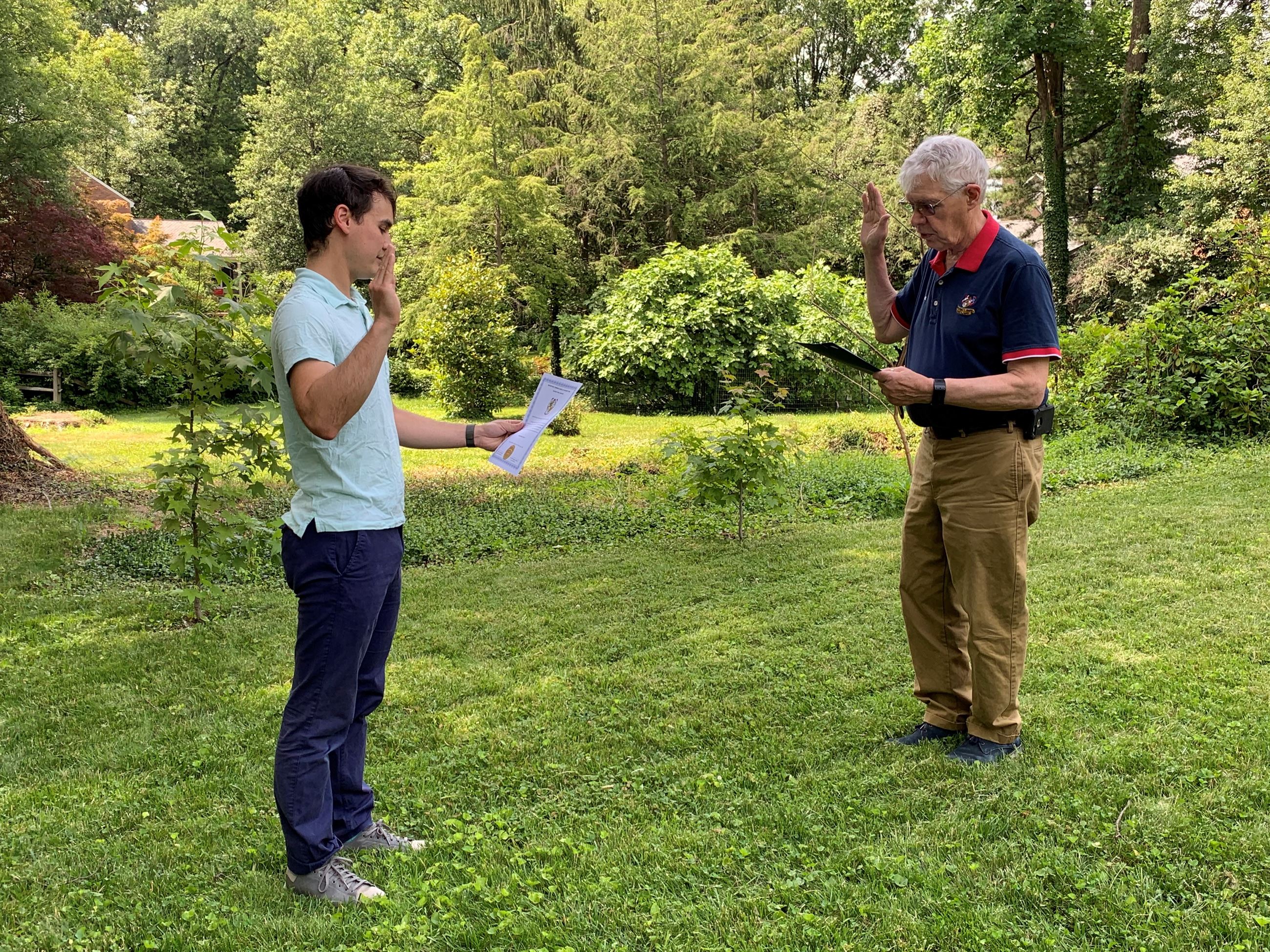 CM McGaughey standing across from Mayor Carey reading the Oath of Office.