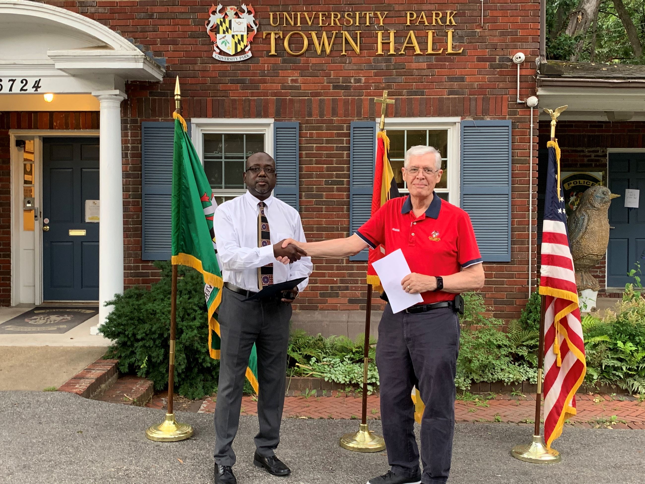 CM Morgan shaking hands with Mayor Carey in front of Town Hall.