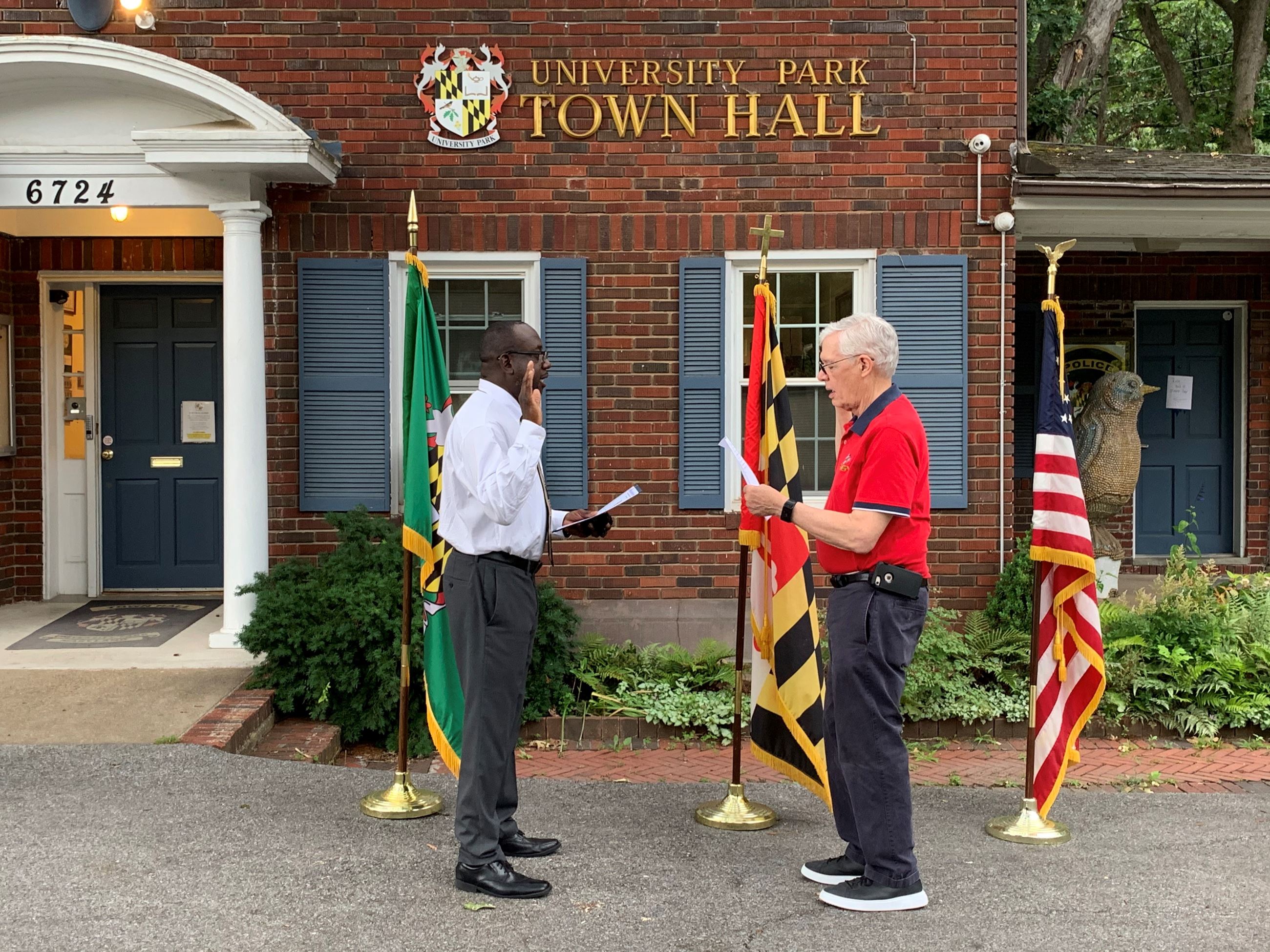 CM Morgan standing across from Mayor Carey reading the Oath of Office in front of Town Hall.