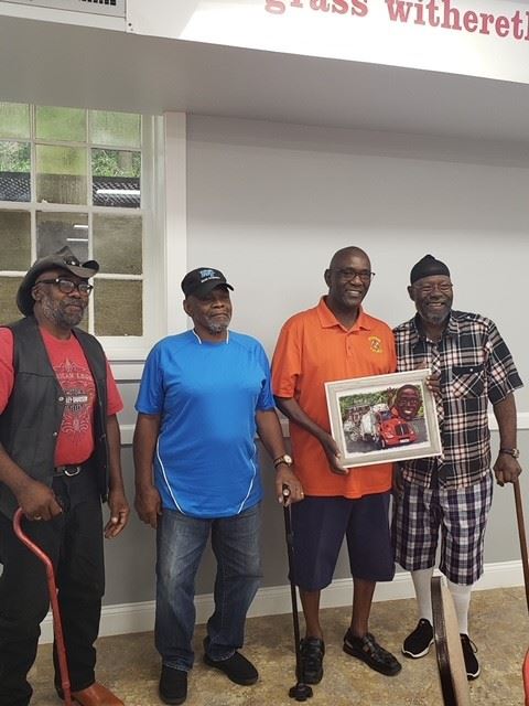 Joe stands with his brother and two cousins